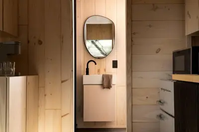 a kitchen with a mirror and a sink in a room at Secluded, Dog Friendly Tiny House on the Hudson River, near Saratoga Springs in Corinth
