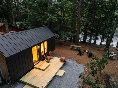 an overhead view of a small cabin with a wooden deck at Secluded, Dog Friendly Tiny House on the Hudson River, near Saratoga Springs in Corinth