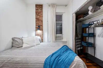 a bedroom with a bed and a window at 2BR Upper East Side near Central Park in New York
