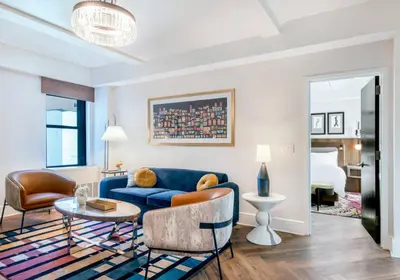 a living room with a blue couch and a table at 2BR Upper East Side near Central Park in New York