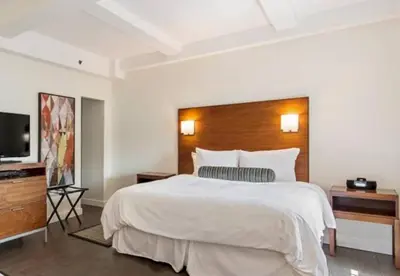 a bedroom with a large bed and a flat screen tv at 3BR Apartment in Big Apple in New York