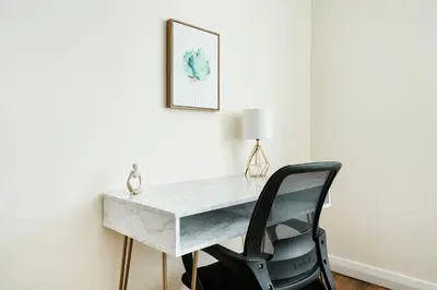 a desk with a chair and a picture on the wall at Lovely and Comfy Studio in NYC in New York