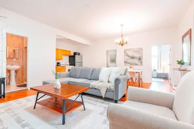 a living room with a couch and a table at Prime Location Upper Manhattan Furnished Apartment in New York