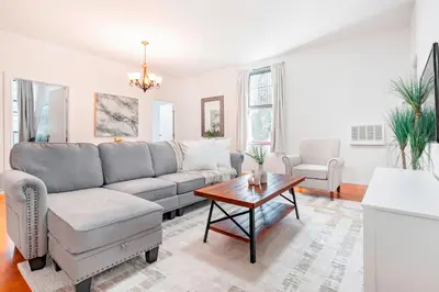 a living room with a couch and a table at Prime Location Upper Manhattan Furnished Apartment in New York