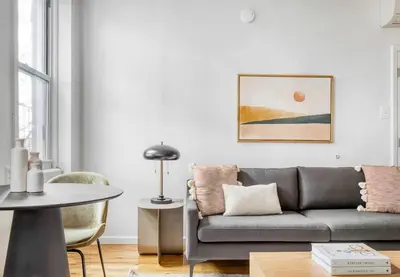 a living room with a couch and a table at Lovely Apt Near Central Park in New York