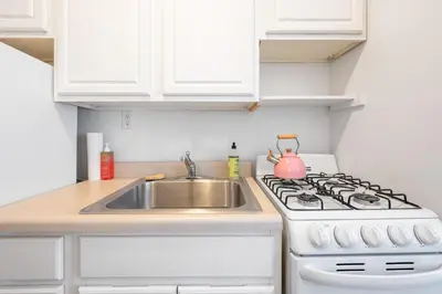 a kitchen with a white stove and a sink at Lovely Apt Near Central Park in New York