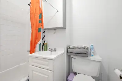 a bathroom with a white toilet and a sink at Lovely Apt Near Central Park in New York