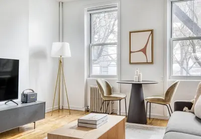 a living room with a couch and a table at Lovely Apt Near Central Park in New York