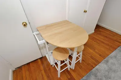 a small table and two stools next to a door at Cozy Studio Steps to Central Park Upper E Side in New York