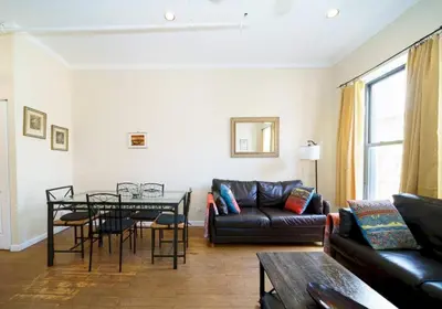 a living room with a couch and a table at Midtown West Furnished Apartment 3BR in New York