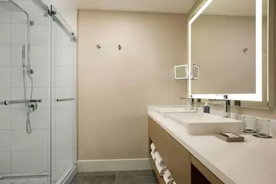 a bathroom with a sink and a shower at The Westin Flushing LaGuardia Airport in Flushing