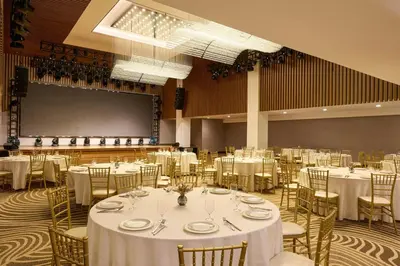 a banquet hall with white tables and chairs at The Westin Flushing LaGuardia Airport in Flushing