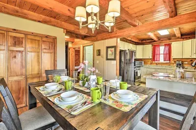 a dining room with a wooden table in a kitchen at The Log Cabin Near Elk Mountain Ski Slopes in Pleasant Mount
