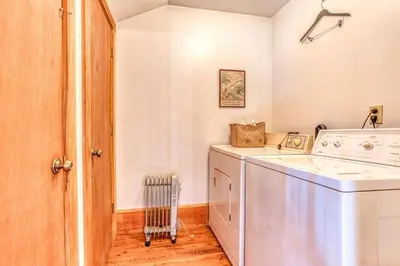 a laundry room with a washer and dryer at Light-filled Carpenter's Cottage in Stockbridge in Stockbridge