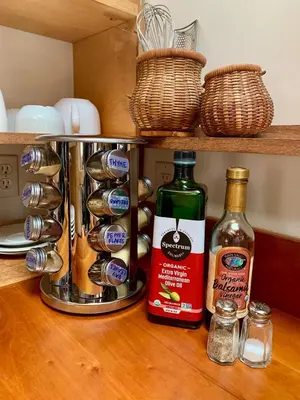 a kitchen counter with two bottles of alcohol and utensils at Light-filled Carpenter's Cottage in Stockbridge in Stockbridge