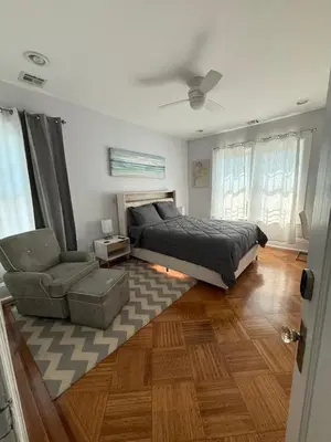 a bedroom with a bed and a couch and a chair at The Grand Parkway is a unique getaway with charm! in East Orange