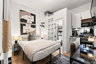 a small room with a bed and a kitchen at Micro Studio Walk to Time Square in New York