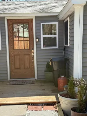 a house with a wooden door and a patio at The Cabins at Walnut Grove-minutes from Hunter and Windham in Ashland