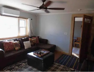 a living room with a couch and a ceiling fan at The Cabins at Walnut Grove-minutes from Hunter and Windham in Ashland