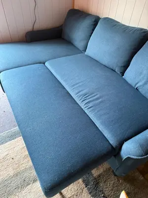 a blue couch sitting in a room at The Cabins at Walnut Grove-minutes from Hunter and Windham in Ashland