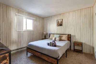 a bedroom with a bed and a window at Game Room Fire Pit Dog Friendly in Tobyhanna