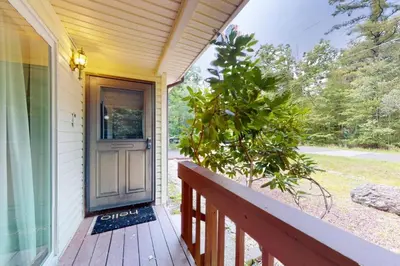 a wooden porch with a door on a house at Sage Grove Sanctuary 3BD Hot Tub Fire Pit in East Stroudsburg