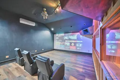 a music room with chairs and a stage in it at Heated Indoor Private Pool Stream Front Game Room in Cresco