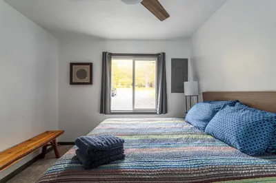 a bedroom with a bed and a window at Lakeside Chalet 3BR Fire Pit Pet Friendly in Tobyhanna