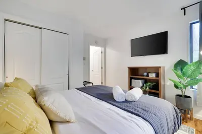 a bedroom with a large bed with towels on it at Cozy 3 BR Game Area Fire Pit in East Stroudsburg