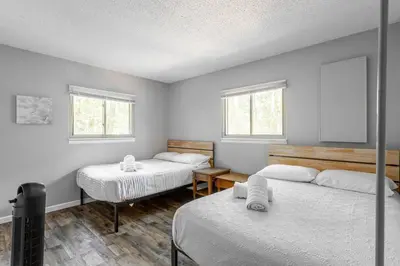 a bedroom with two beds and two windows at Cozy 3Br Fire Pit Hammock 2 Minutes to Beach in East Stroudsburg