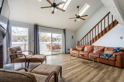 a living room with a couch and some chairs at Tranquil Shores Waterfront Fire Pit Hammock in Tobyhanna