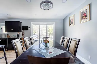 a dining room with a glass table and chairs at The Woodland Escape Pool Table Fire Pit 4 BD in Tobyhanna