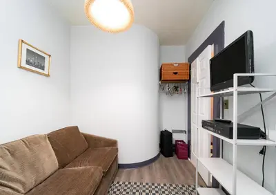 a living room with a couch and a tv at Charming 3-Bedroom Apartment in Midtown West in New York