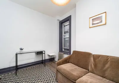 a living room with a couch and a window at Charming 3-Bedroom Apartment in Midtown West in New York