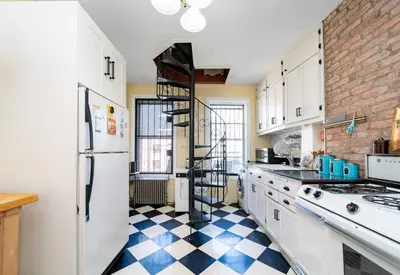 a kitchen with a black and white checkered floor at Charming 3-Bedroom Apartment in Midtown West in New York