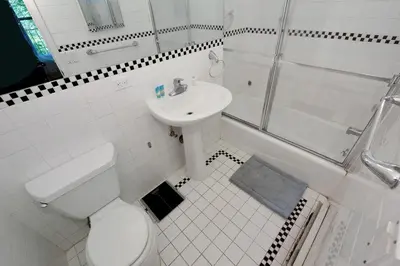 a bathroom with a toilet and a sink and a shower at Charming 3-Bedroom Apartment in Midtown West in New York