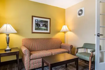 a living room with a couch and a chair at Hamden Hotel and Suites HAMDEN - NEW HAVEN in Hamden