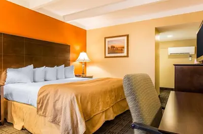 a hotel room with a large bed and a desk at Hamden Hotel and Suites HAMDEN - NEW HAVEN in Hamden