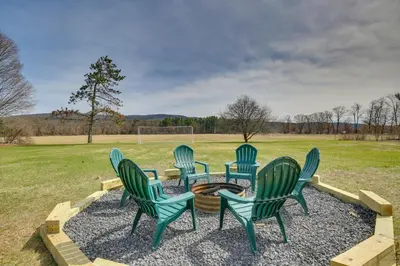 a group of chairs sitting around a table in a field at 4 Mi to Great Barrington Berkshires Retreat! in Sheffield