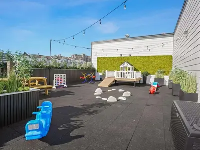 a patio with a play area with a playground at The Platinum Downtown Stamford Studio Getaway in Stamford
