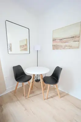a table and two chairs in a room at The Platinum Downtown Stamford Studio Getaway in Stamford