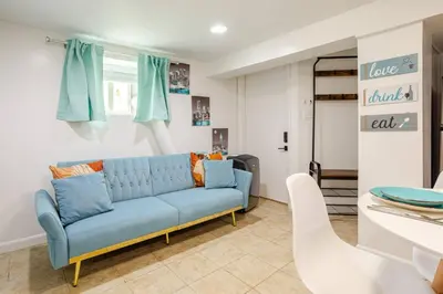 a living room with a blue couch in a room at Big City Life: 1BR Apt wNetflix Easy NYC Access in Jersey City