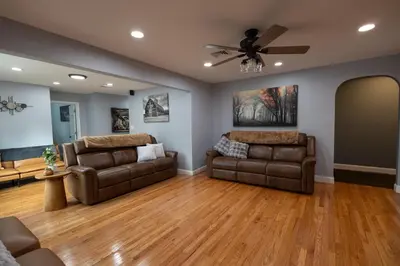 a living room with two couches and a ceiling fan at R&C Getaway in Greenville