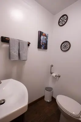 a bathroom with a white toilet and a sink at R&C Getaway in Greenville