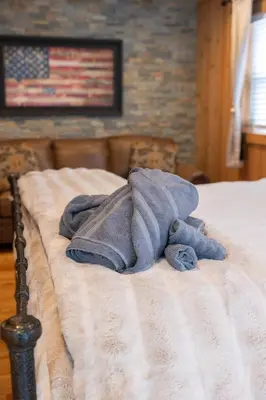 a blue towel laying on a bed with an american flag at R&C Getaway in Greenville