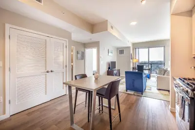 a kitchen and dining room with a table and chairs at Gorgeous Apt w Harbor Views & Gym in South End