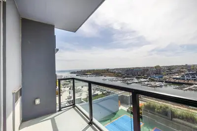 a balcony with a view of the water at Gorgeous Apt w Harbor Views & Gym in South End