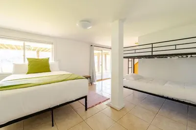 a bedroom with two beds and a large window at Modern Lakefront Retreat w King Bed in Saugerties