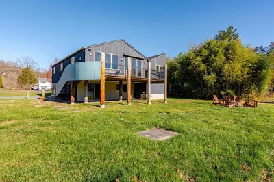 a house in a field with a grassy yard at Modern Lakefront Retreat w King Bed in Saugerties
