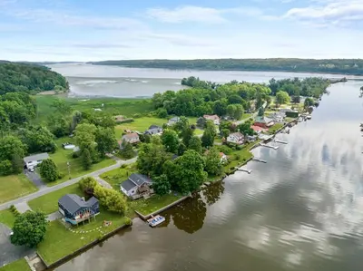 an aerial view of a village on a river at Modern Lakefront Retreat w King Bed in Saugerties